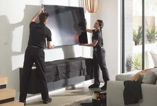 Professional TV mounting installation — clean, secure wall installation with cable management